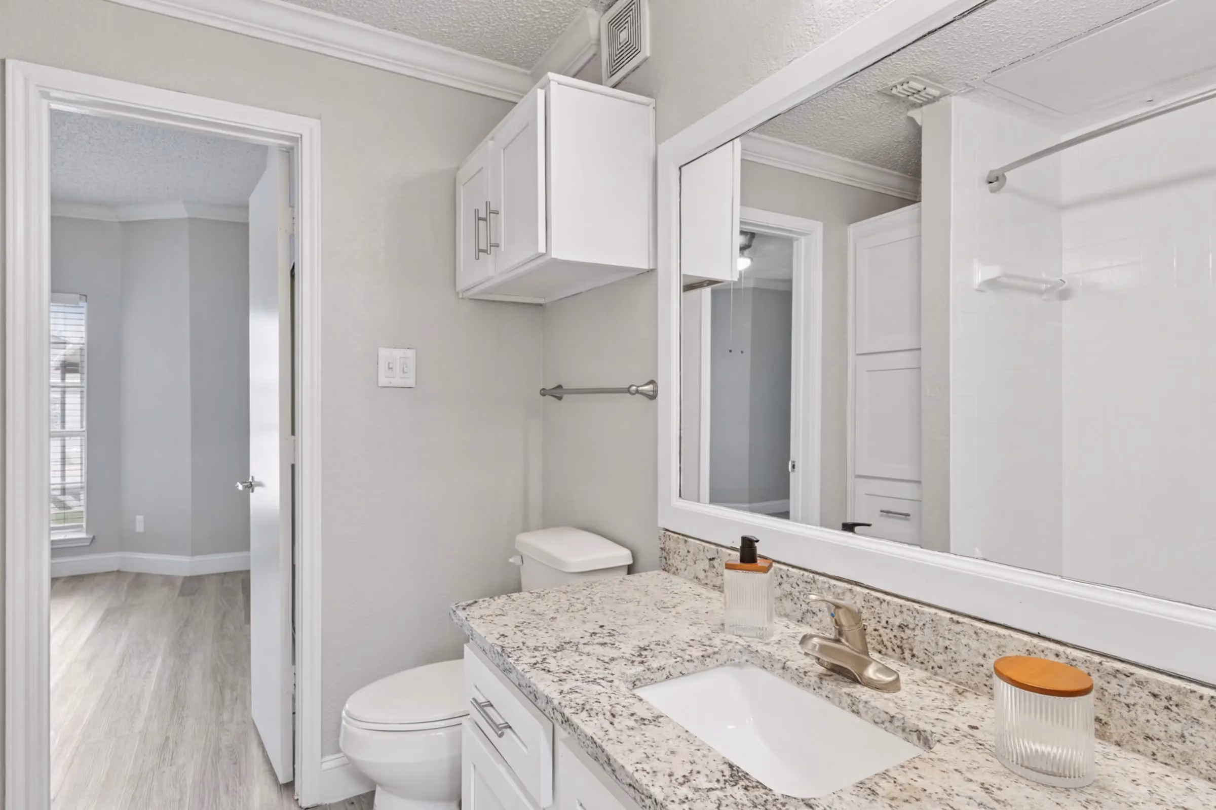 Bathroom with white cabinets at Willow Ridge Townhomes and Apartmnets in Euless, Texas