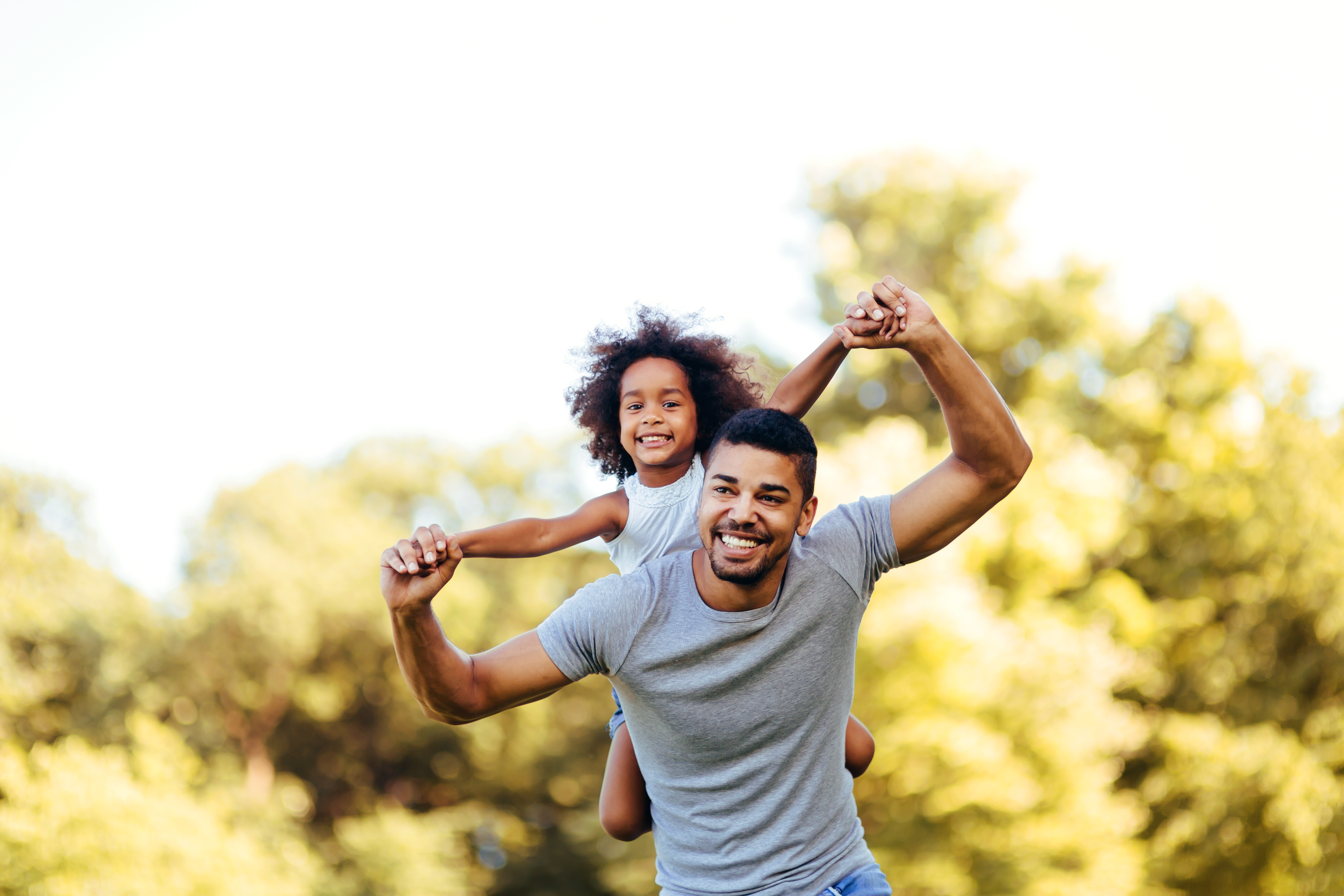 Man with child on back stock image