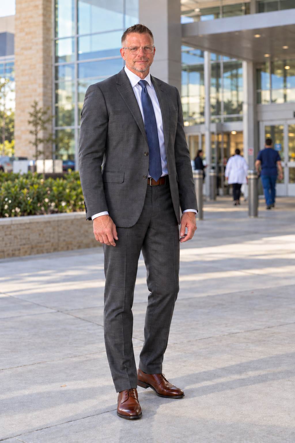 Douglas Duffield standing outside a contemporary hospital.