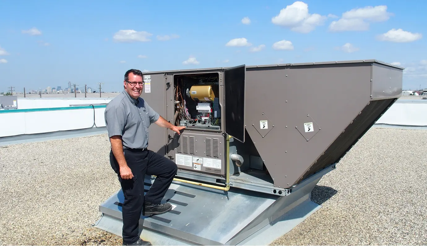 Nordic technician servicing a rooftop HVAC unit