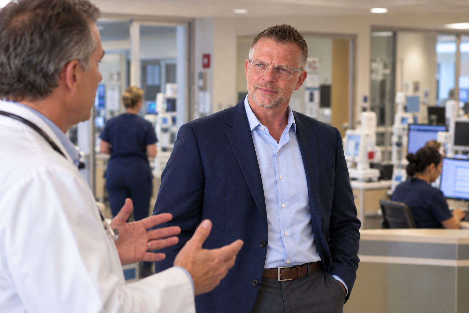Douglas Duffield listening to a physician in an active hospital clinical unit.