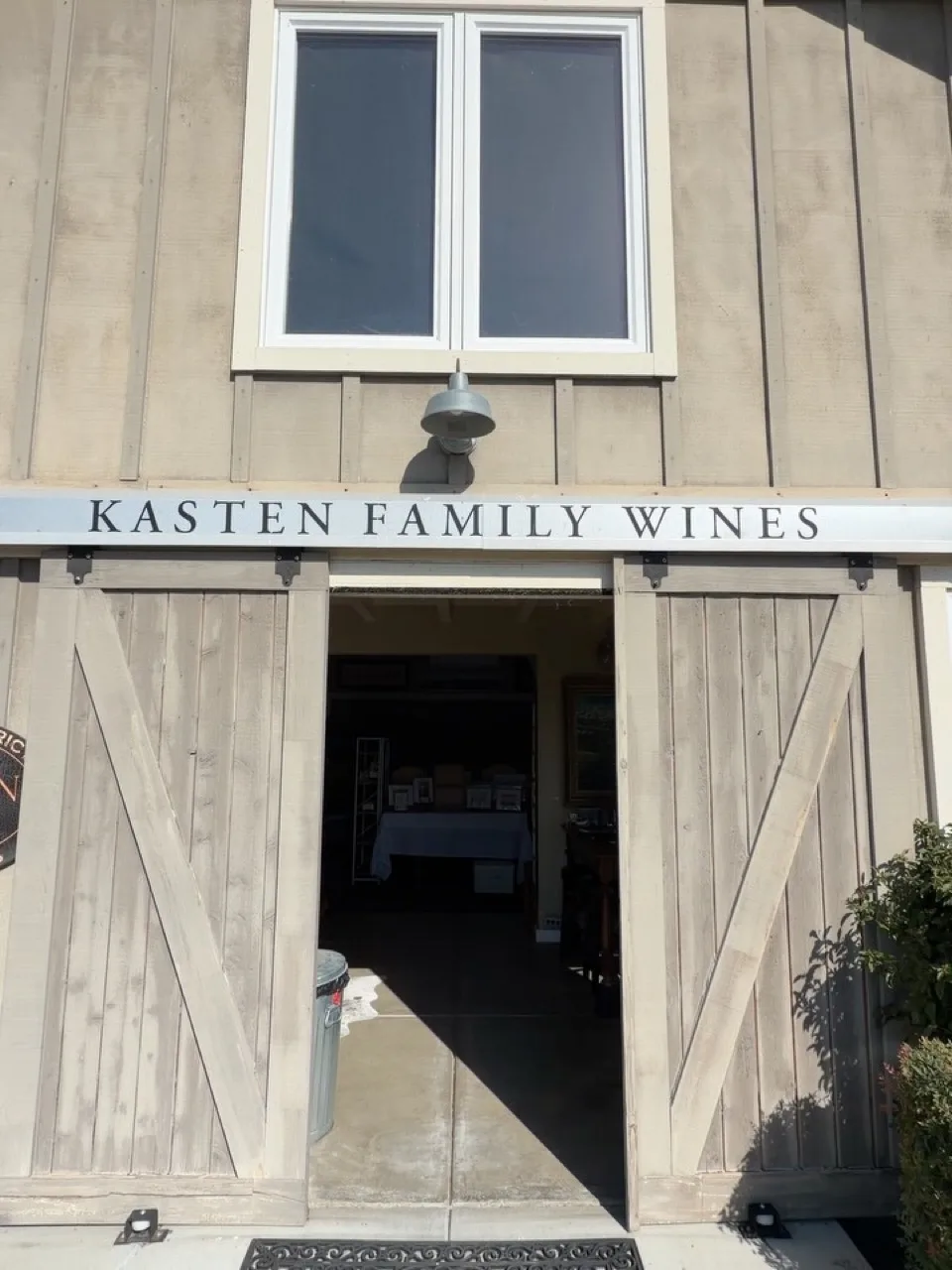 The barn doors of Kasten Family Wines under its painted sign.