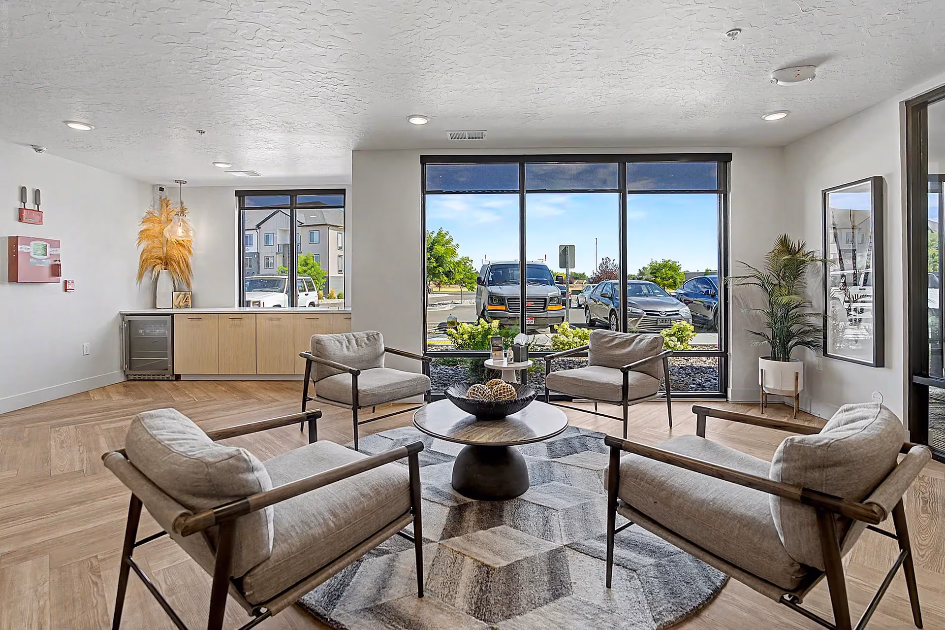 Clubhouse seating area with large windows and view of parking lot