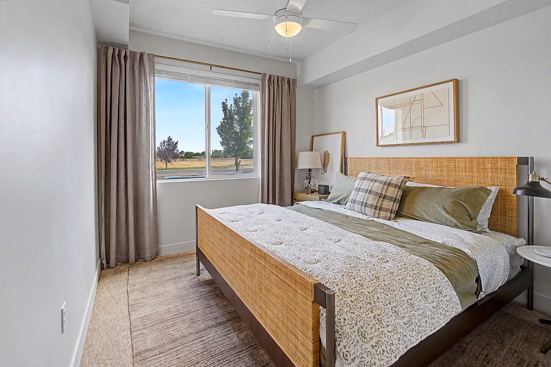 Furnished, carpeted bedroom with ceiling fan