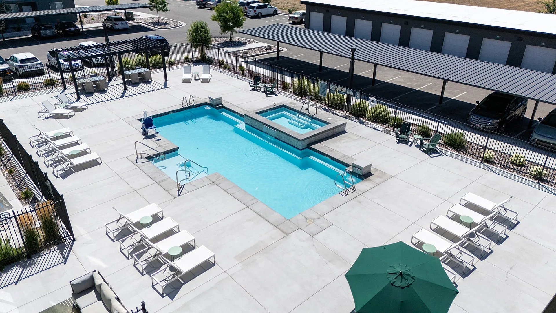 Aerial view of pool and spa area surrounded by lounge seating