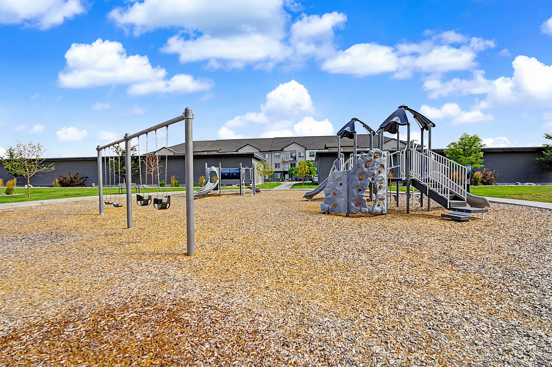 Playground with two structures and a swingset