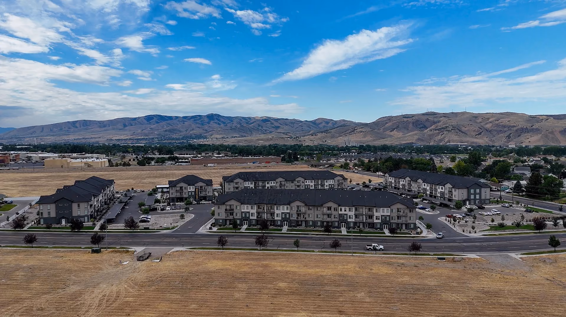Aerial view of Via Apartments with view of mountains