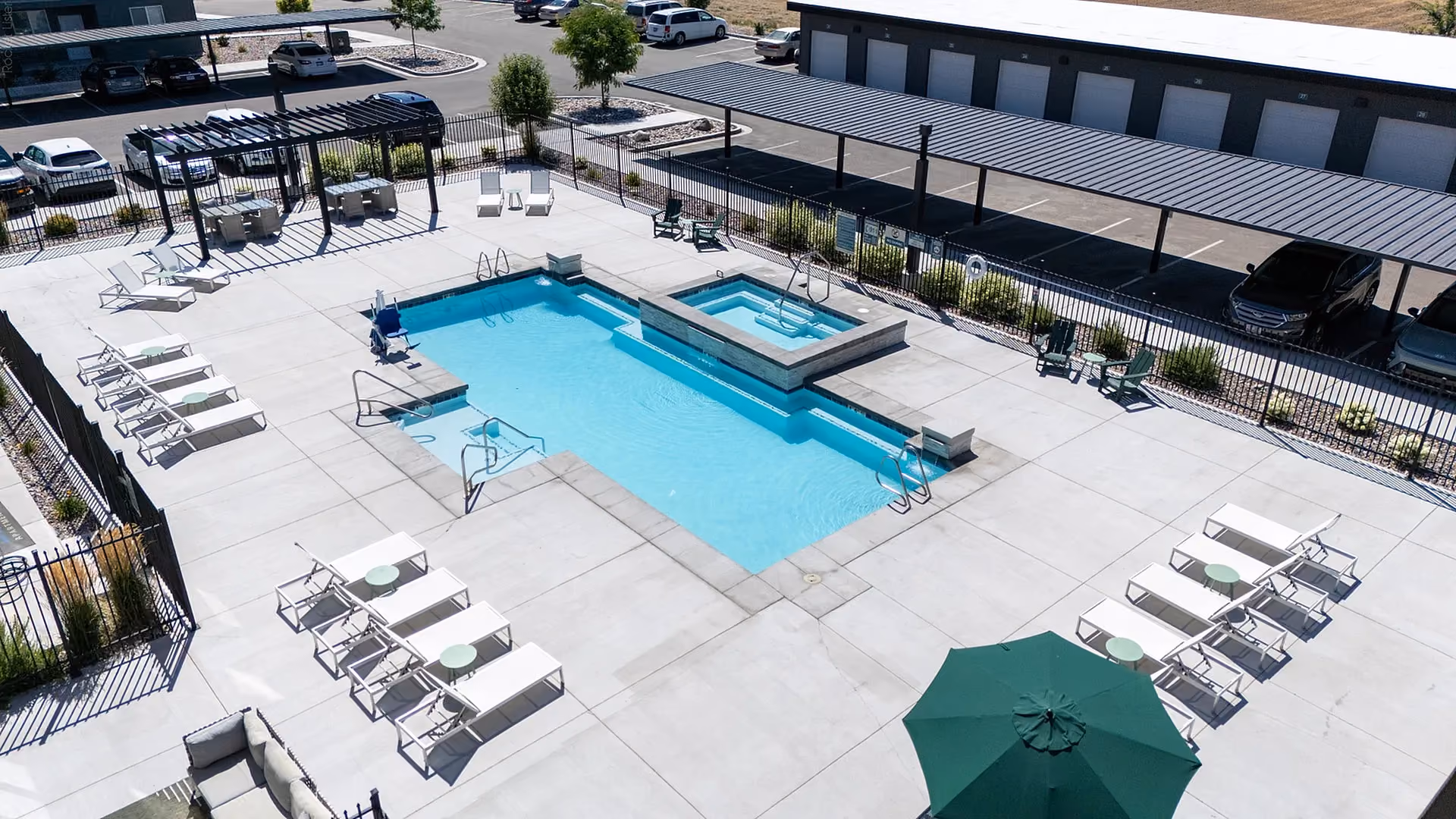 Aerial view of pool and spa area surrounded by lounge seating