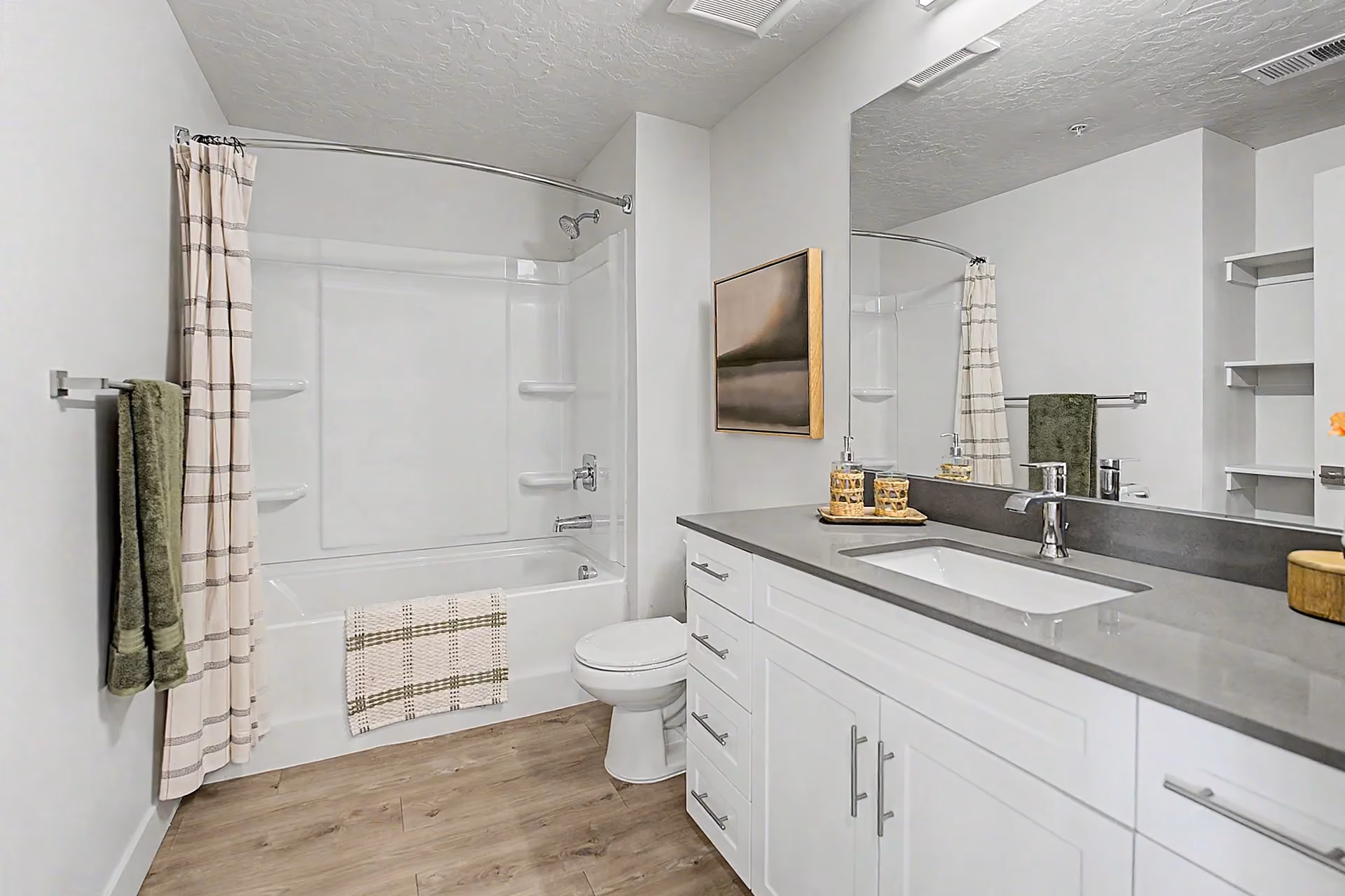 Bathroom with white cabinet vanity and bathtub with built in shelving