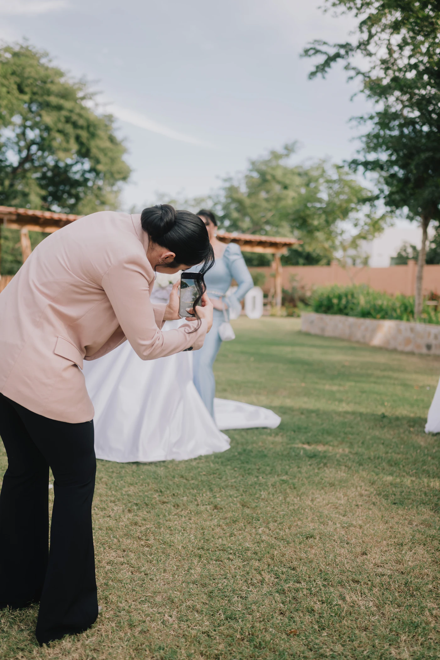 Wedding professional photographing a bride on her wedding day