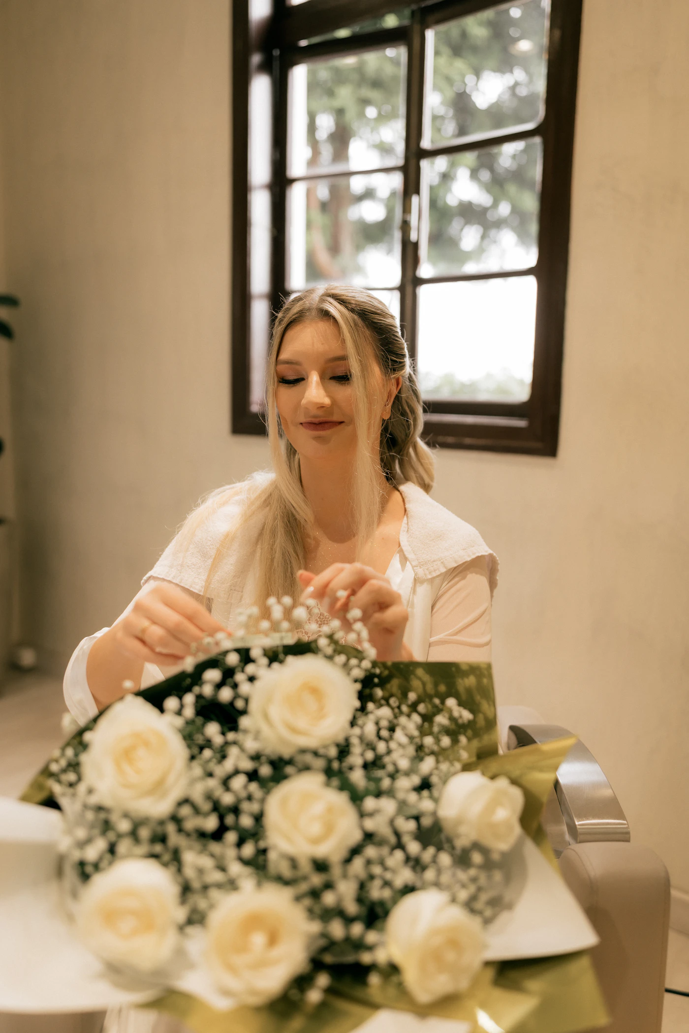 Florist arranging white roses and baby's breath for a wedding
