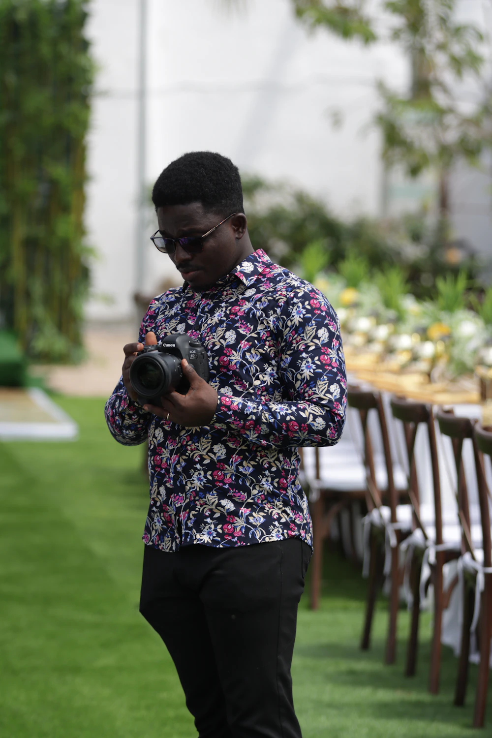 Wedding photographer checking his camera at a reception setup