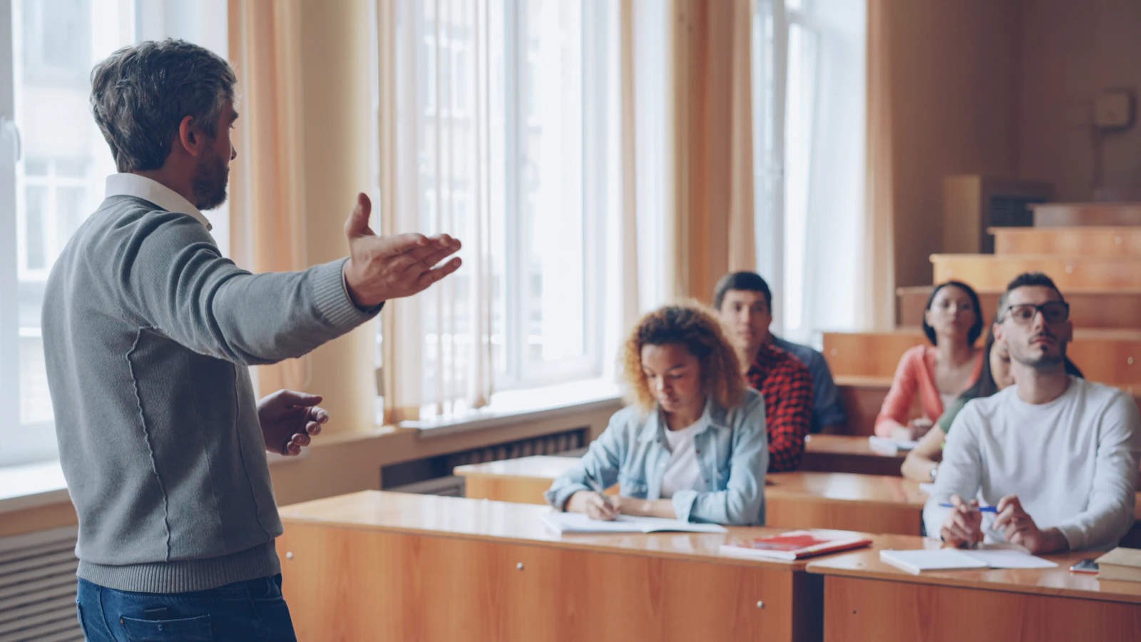 Instructor leading a discussion with adult students in a classroom