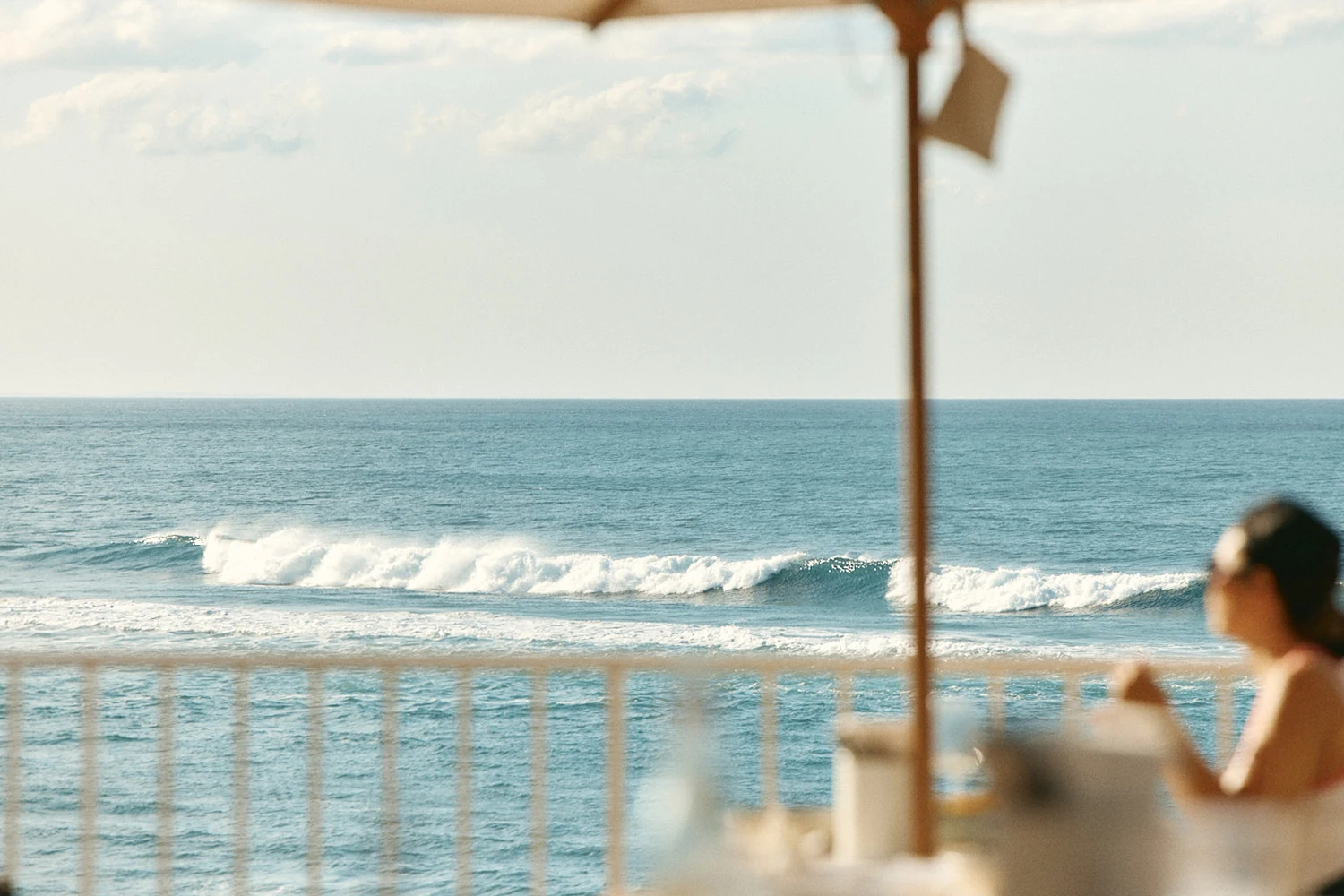Waves breaking off Burleigh Heads, seen from the terrace under an umbrella