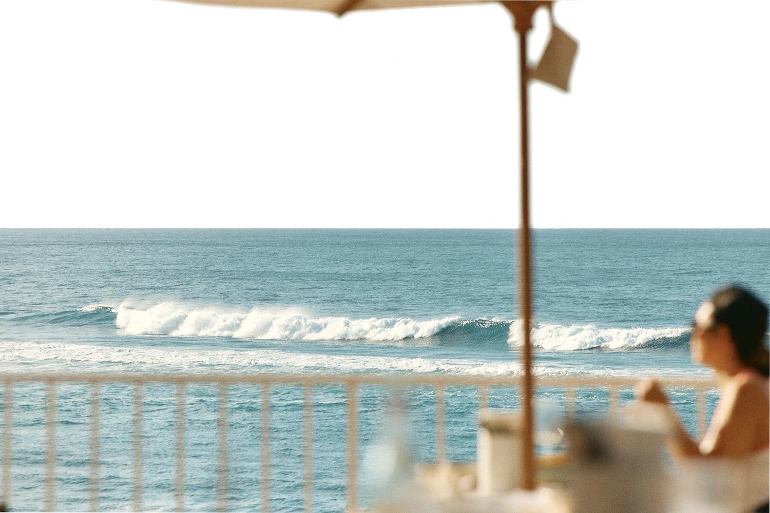 Waves breaking off Burleigh Heads, seen from the terrace under an umbrella