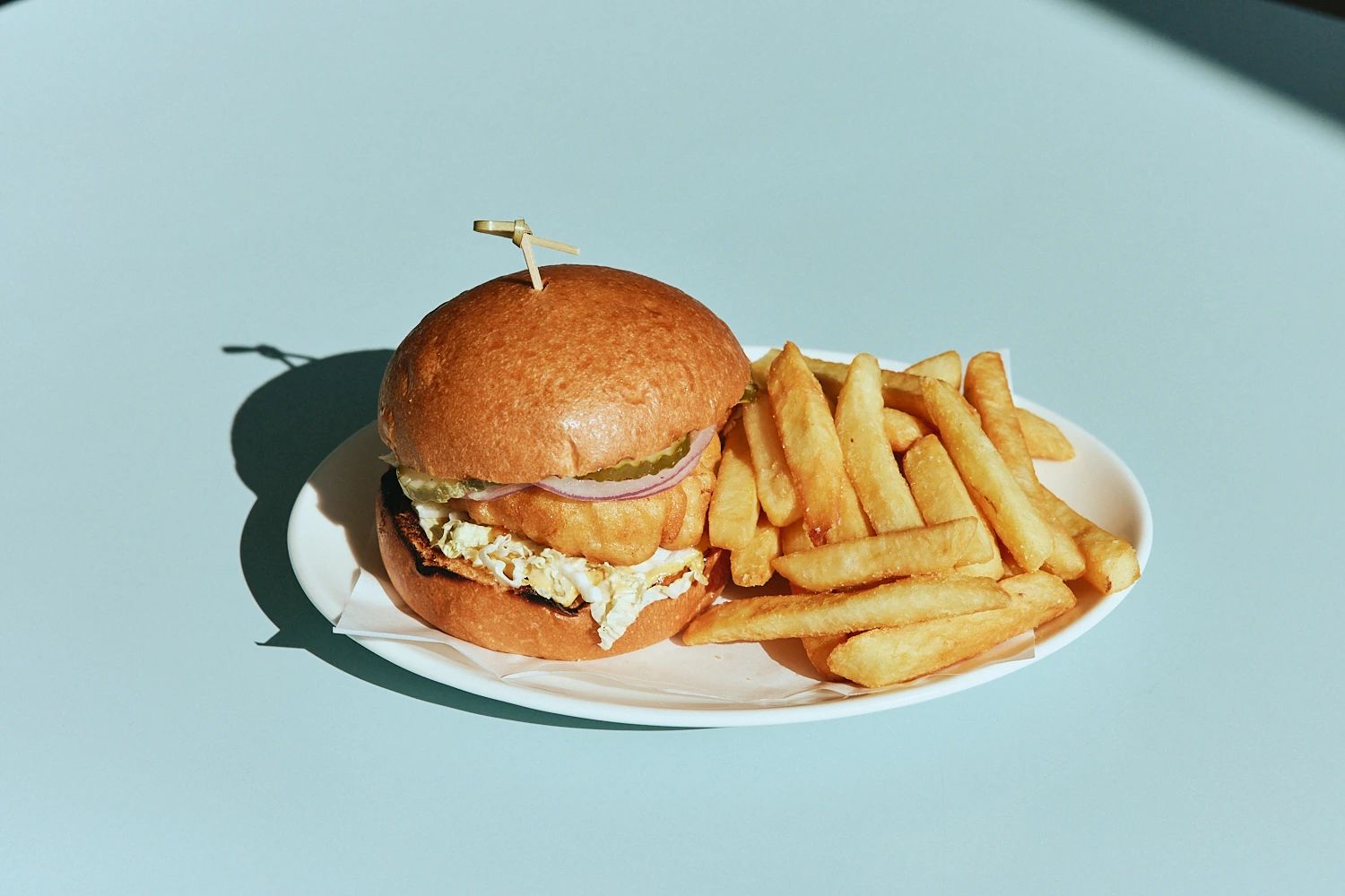 Crispy chicken burger with slaw and fries at The Pav