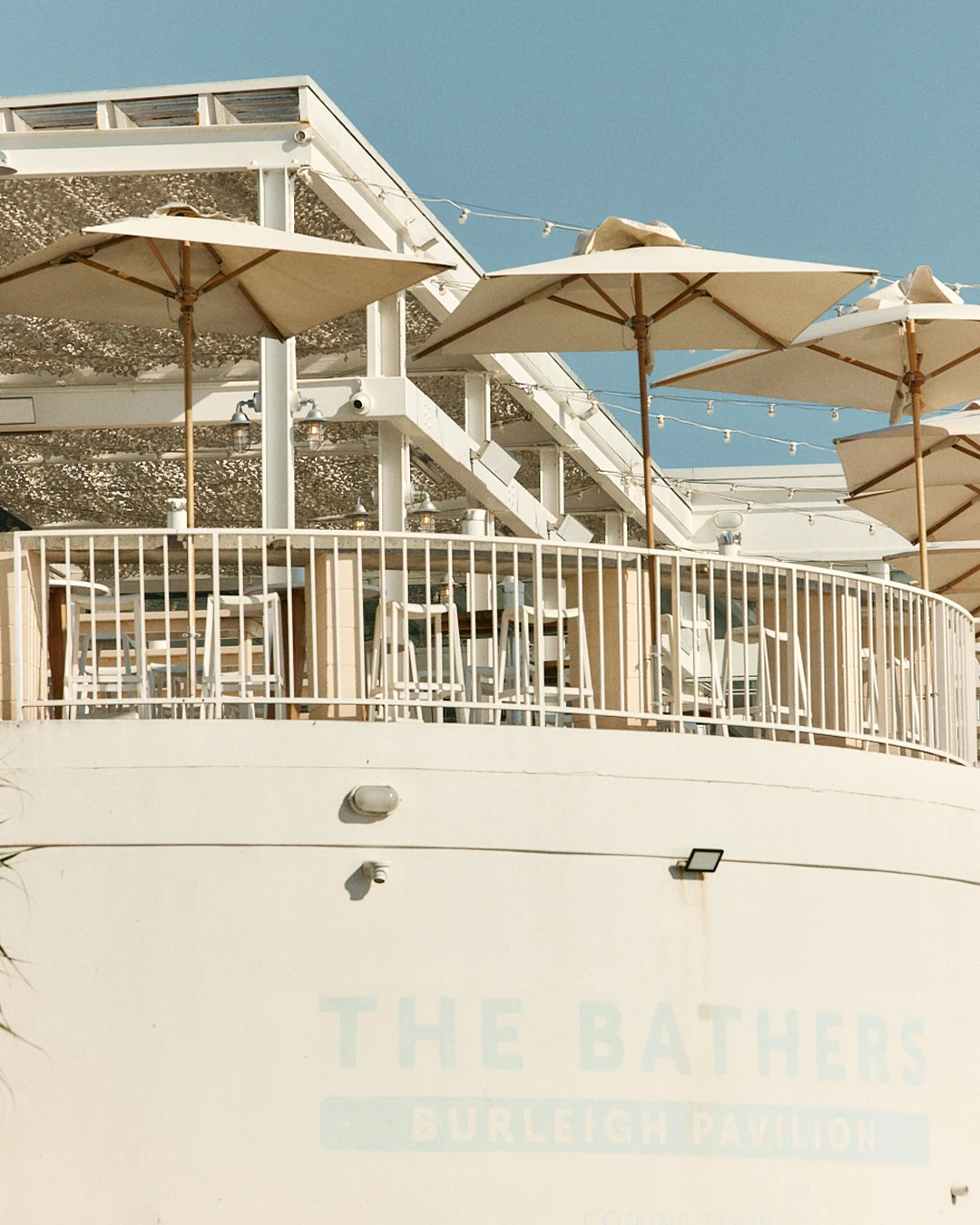 The Bathers signage below the umbrella-lined upper deck of Burleigh Pavilion