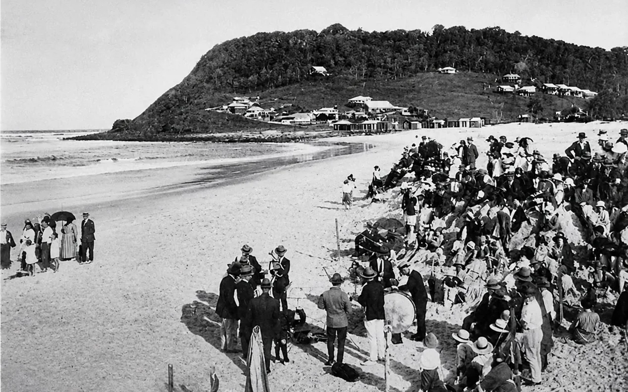 Black and white photo of a large crowd gathered on the beach at Burleigh Heads in the early days