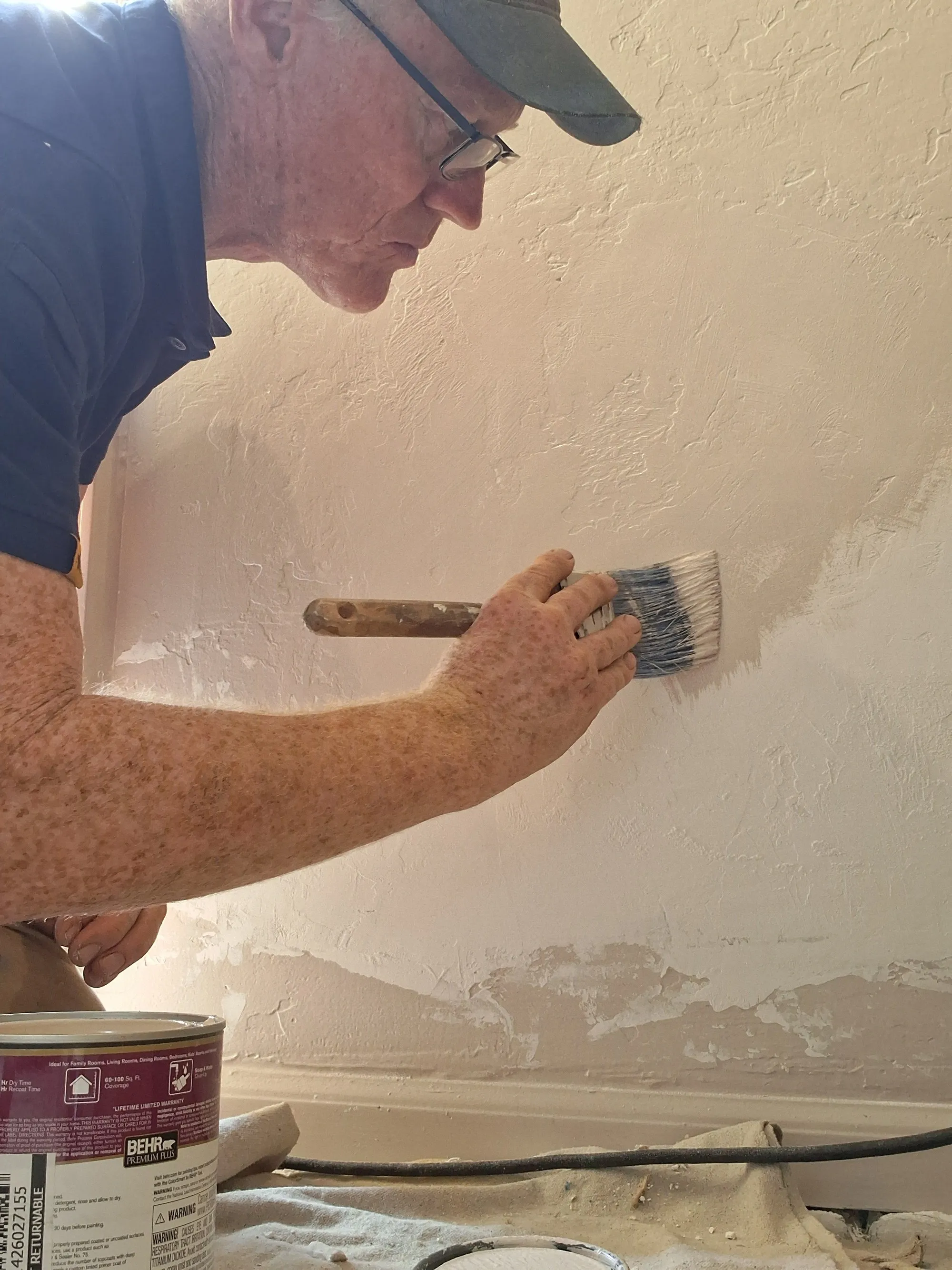 Steve Riddle painting an interior wall