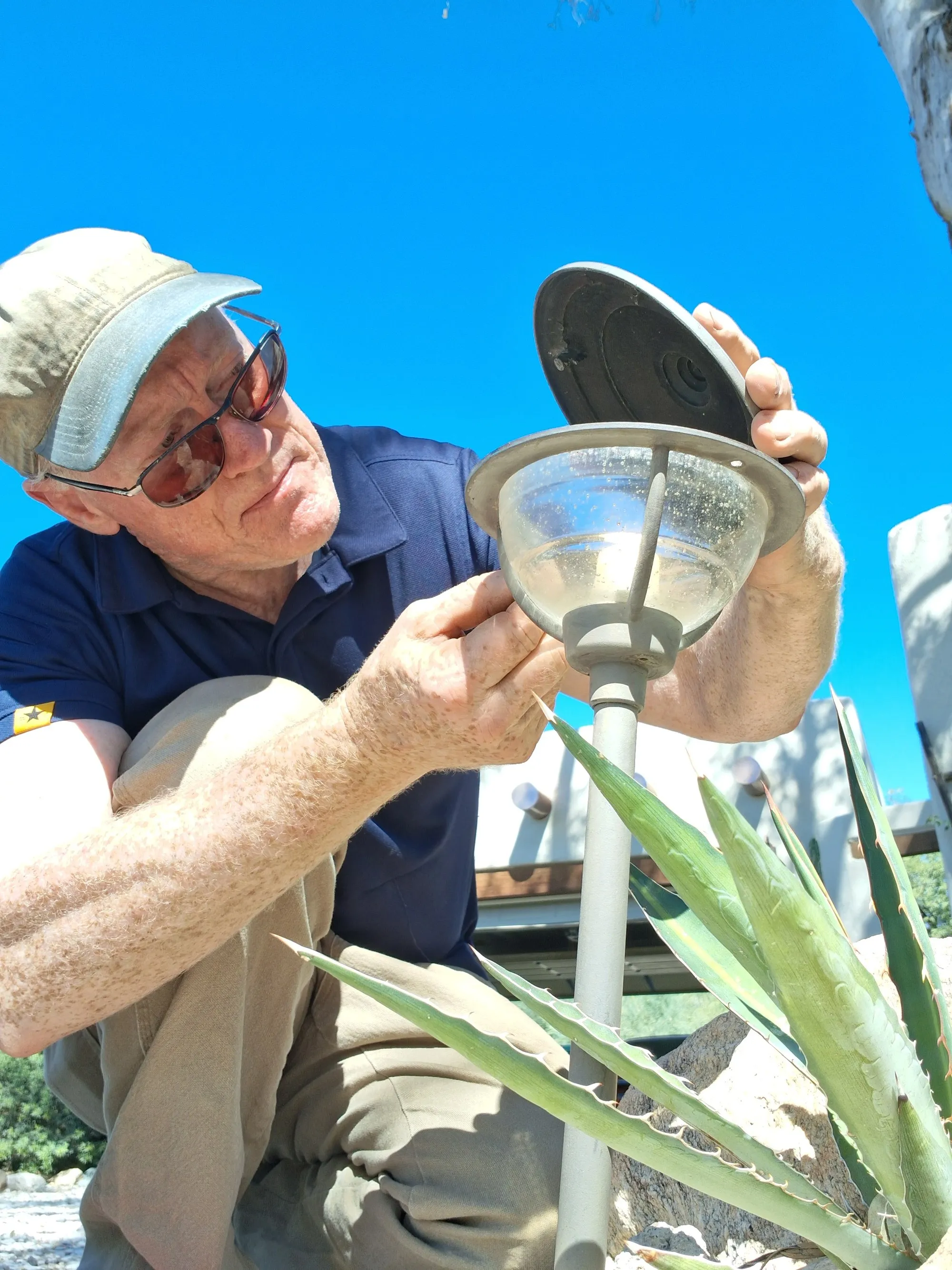 Steve Riddle repairing an outdoor light fixture