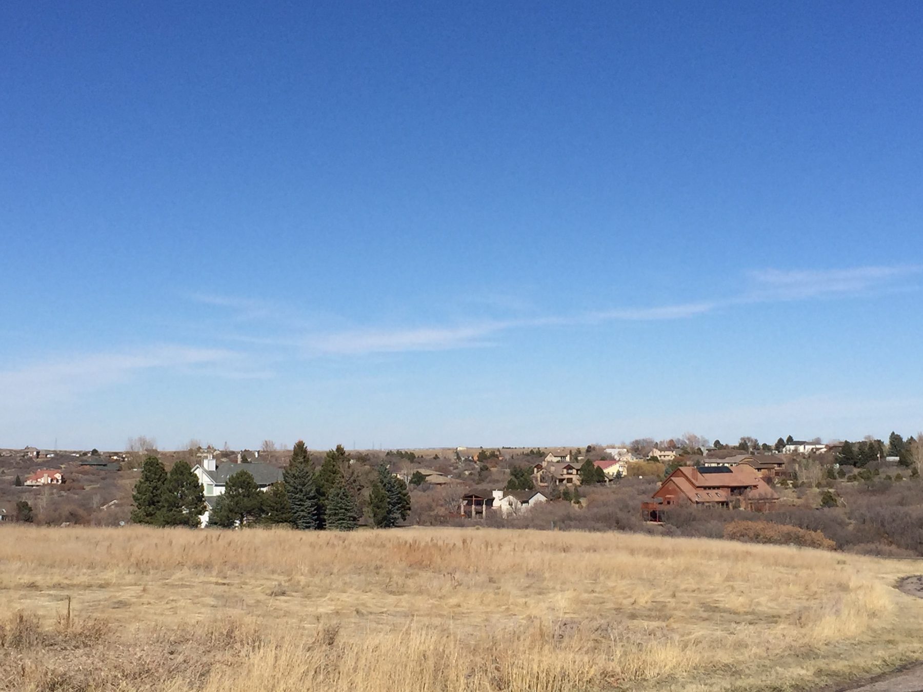 Open space and homes under a blue sky