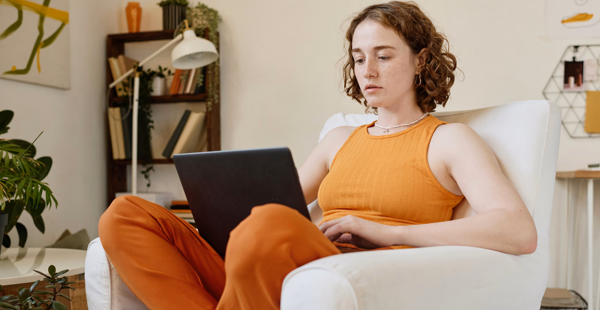 a woman blogs while sitting on a couch