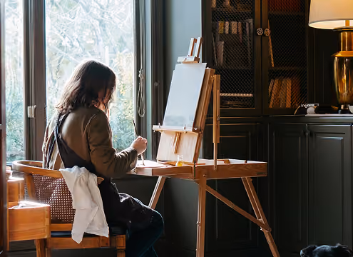 a woman paints in her studio