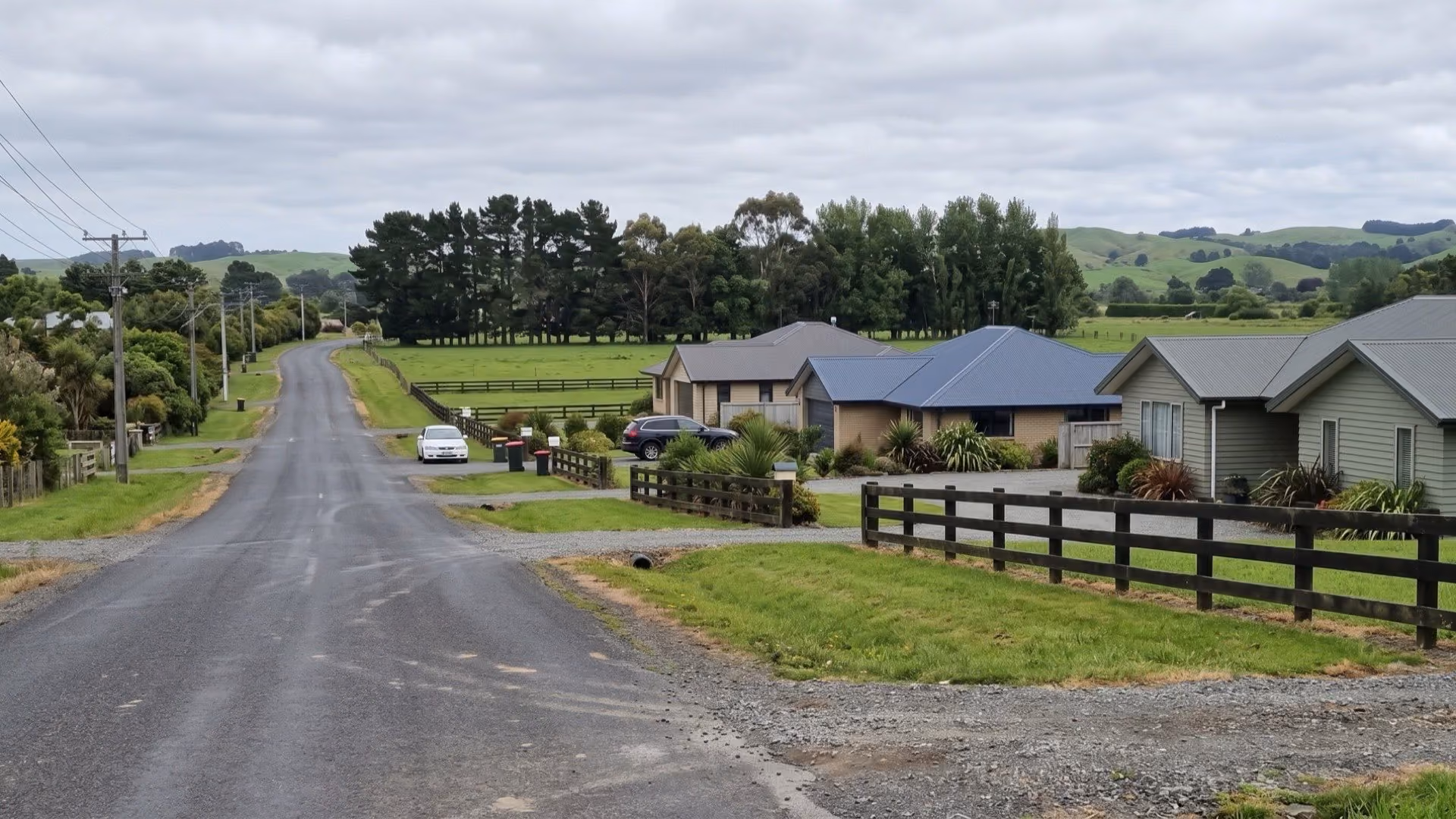 Quiet semi-rural street with family homes and paddocks in Huapai, Auckland