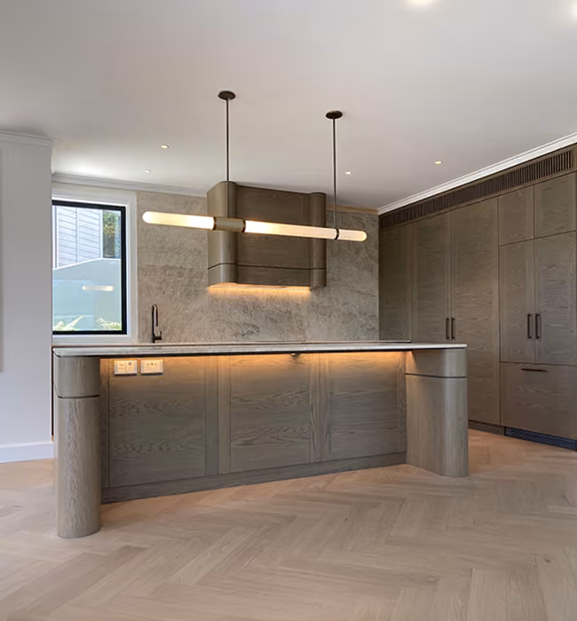 Kitchen island with a canopy rangehood, linear pendant and under-bench LED lighting