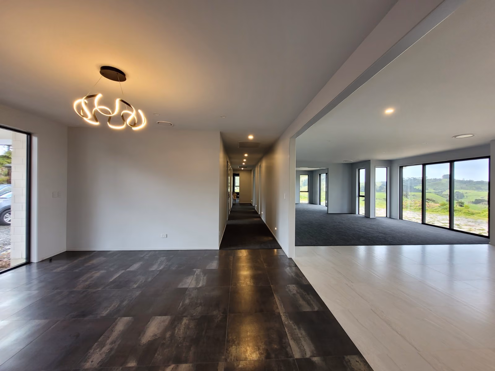 LED downlights and a feature pendant along a hallway in a new home