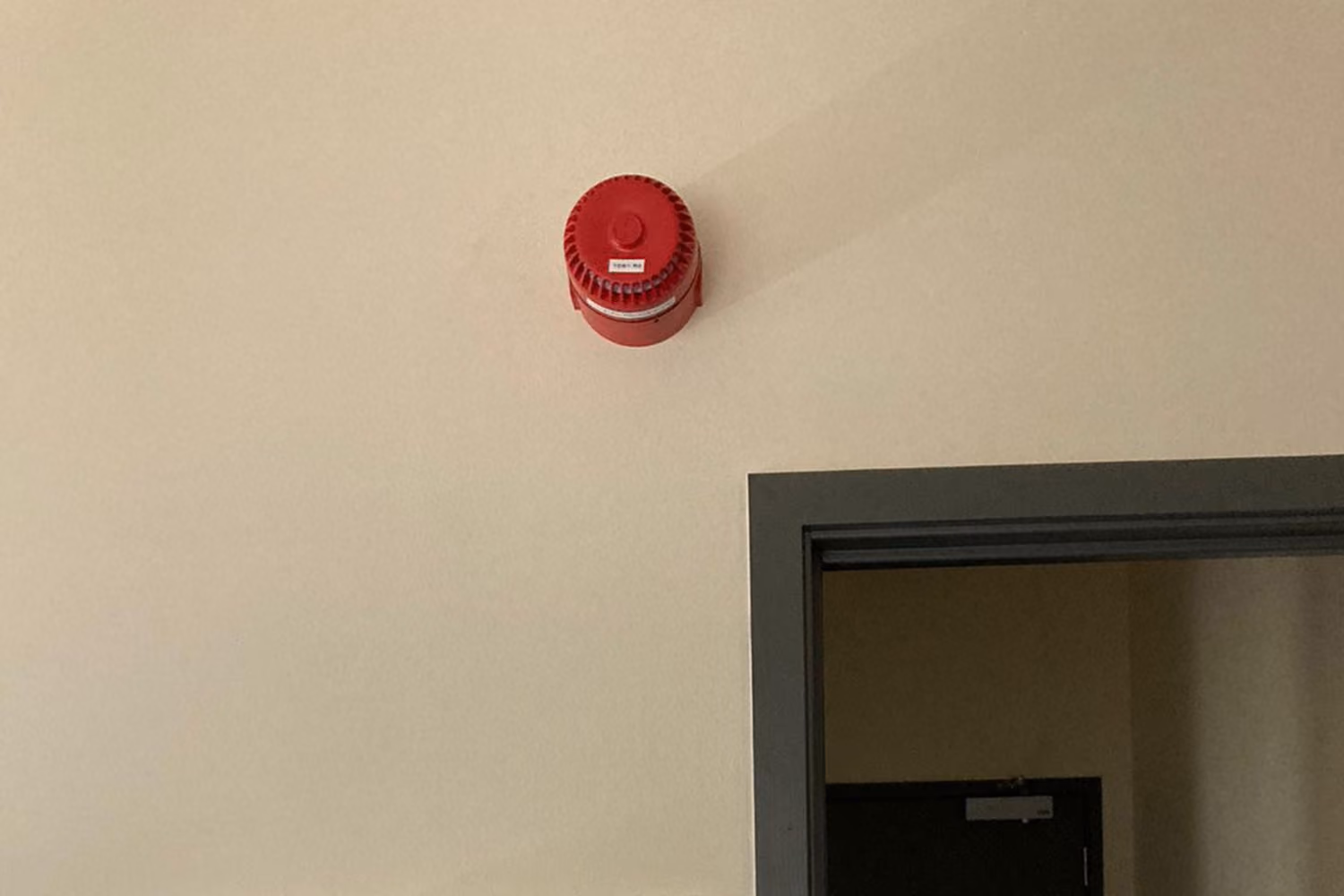 Emergency siren mounted above a doorway at Milford Primary School