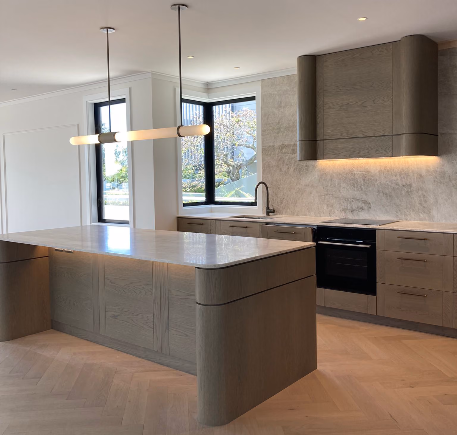 New kitchen with a canopy rangehood, pendant light and under-bench lighting