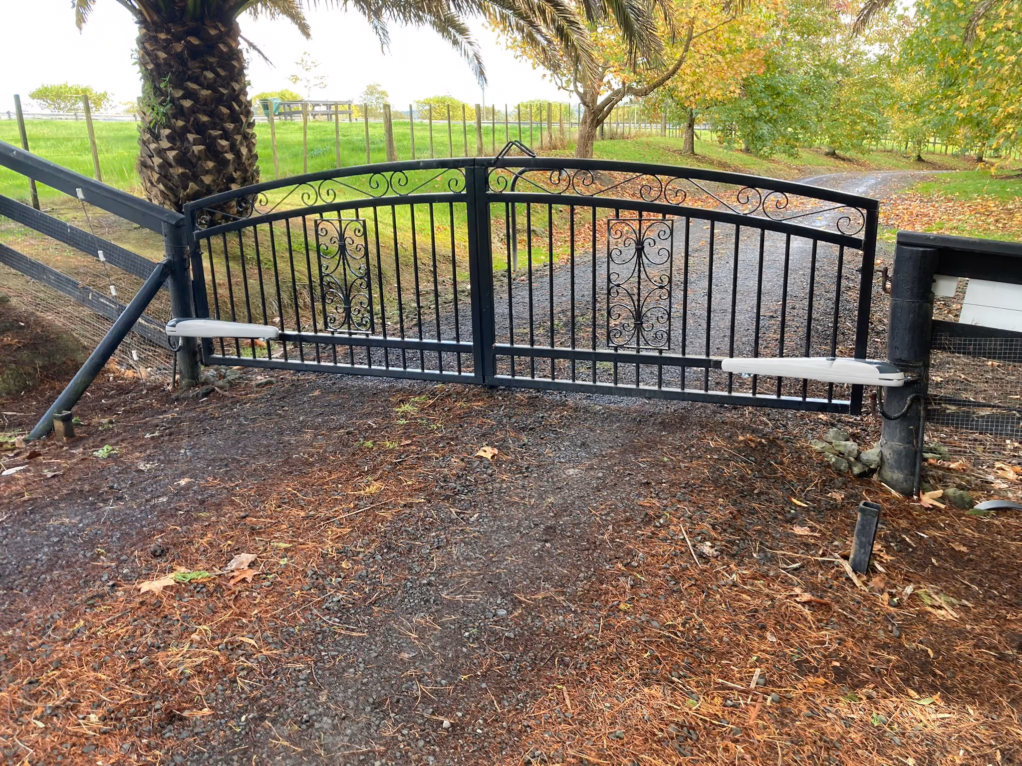 Driveway gates fitted with electric gate motors on a rural property