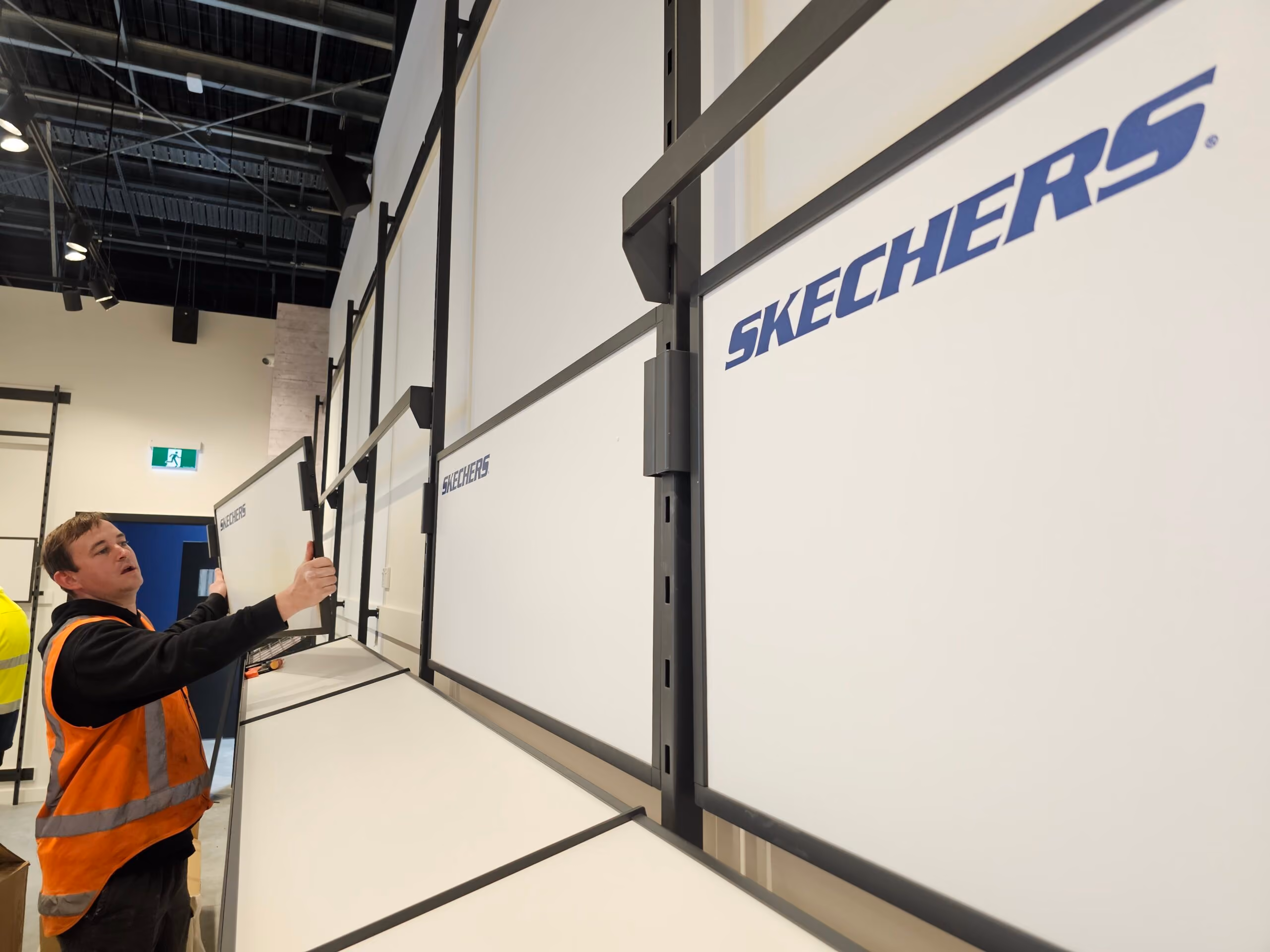 Livewire electrician fitting off lighting at Skechers Manawa Bay