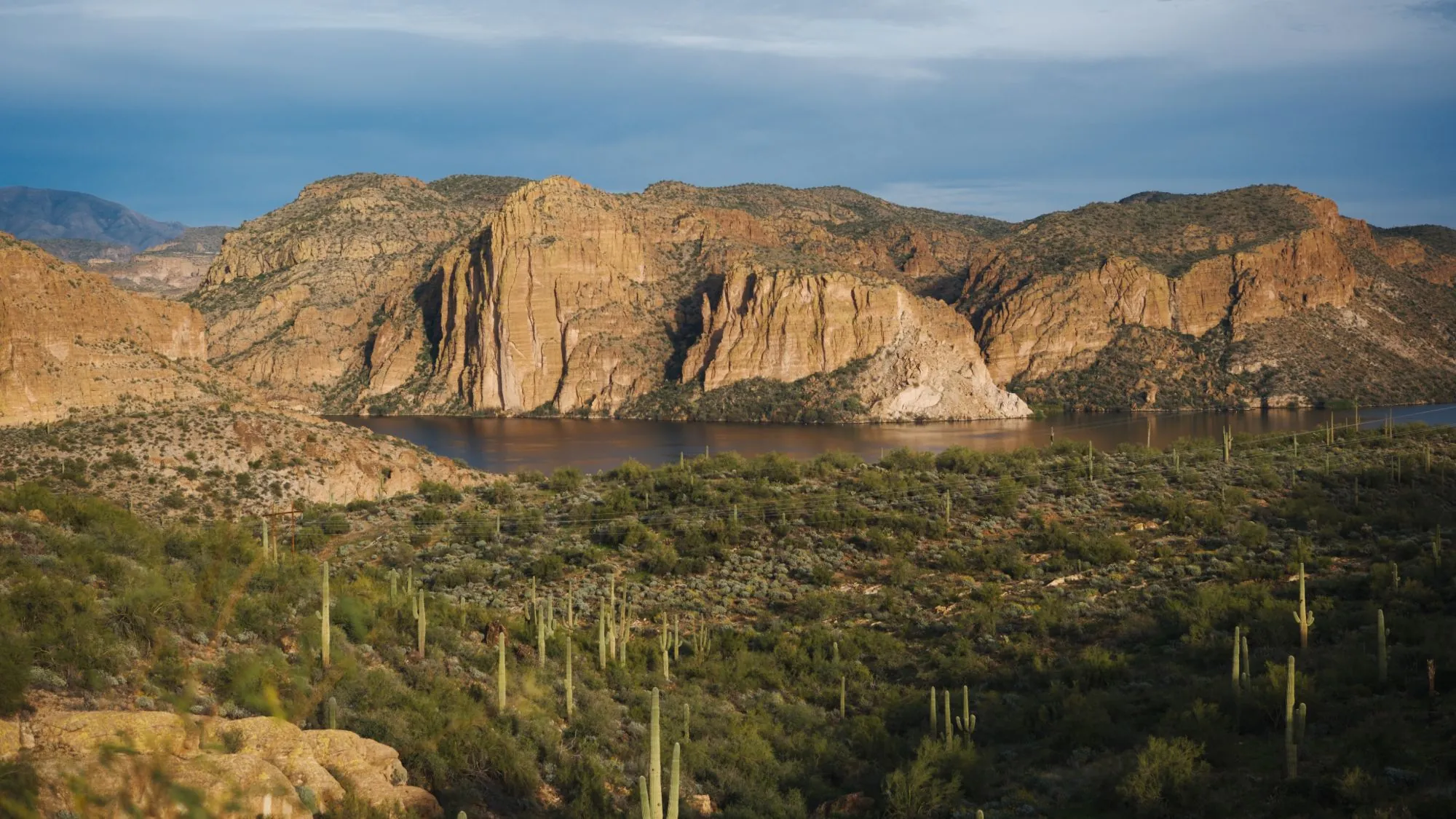 Late light on the red cliffs above Canyon Lake, Arizona, with saguaros on the slope