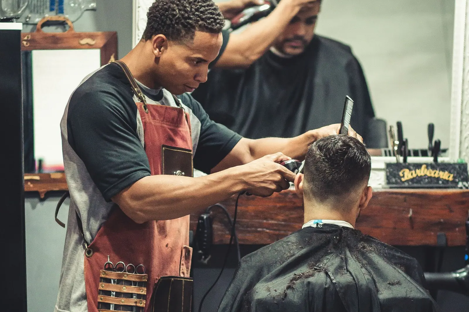 A barber cutting a client's hair inside Northside Clippers. Illustrative photo.