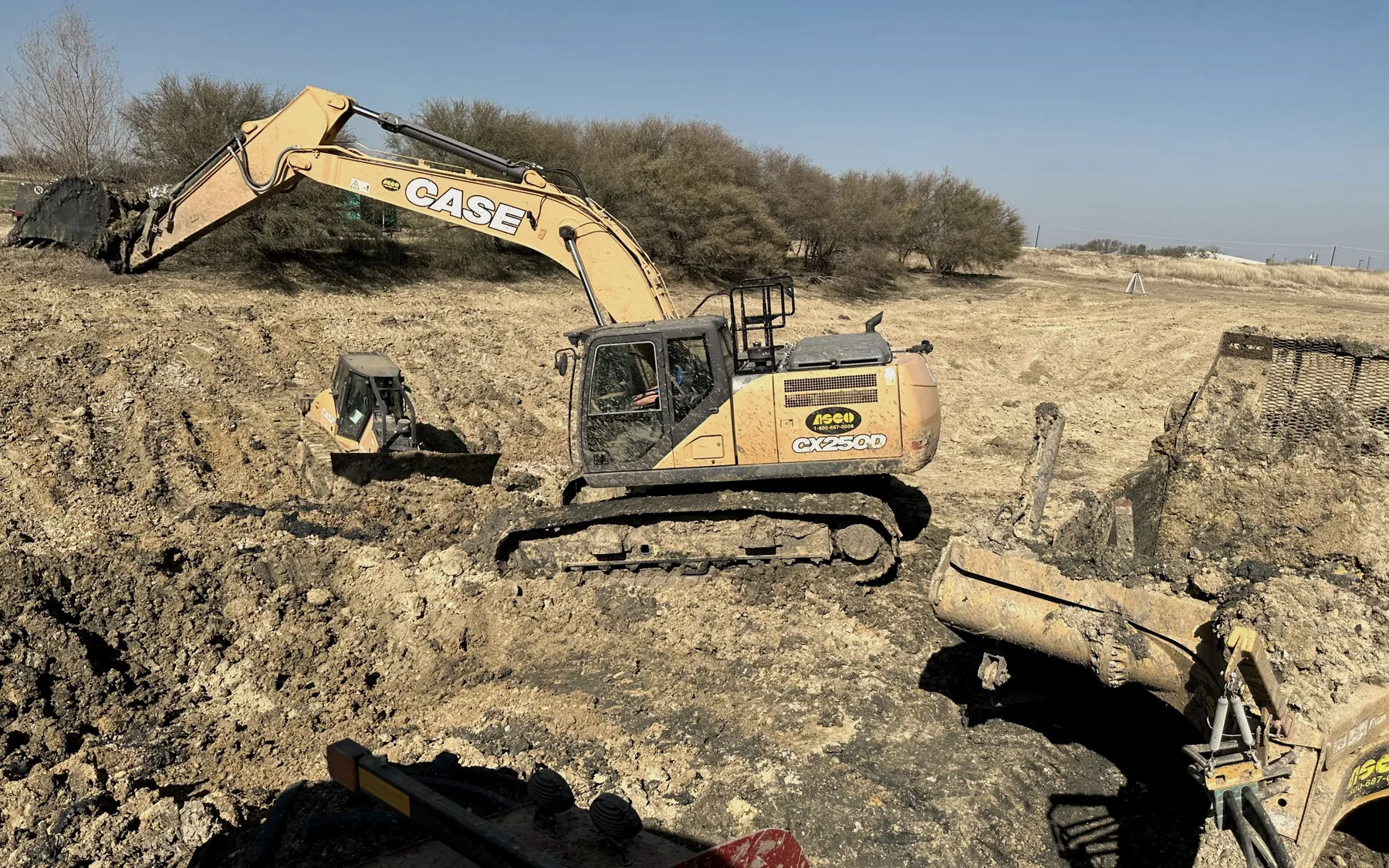 Flying G excavator and skid steer clearing and grading a site