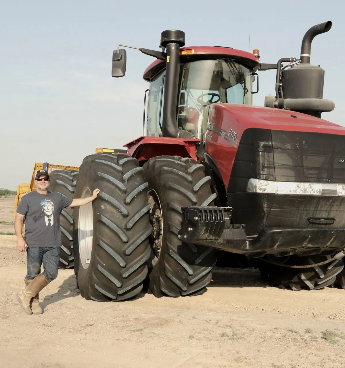 Flying G Excavation owner beside a Case IH tractor