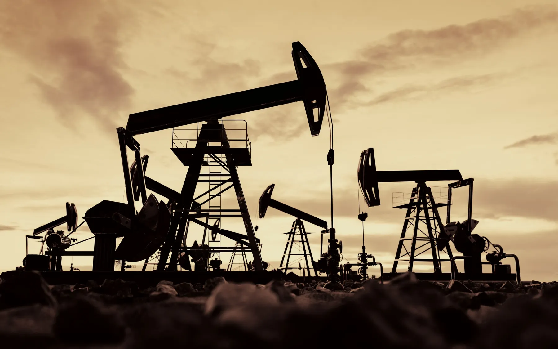 Oil field pump jacks at sunset