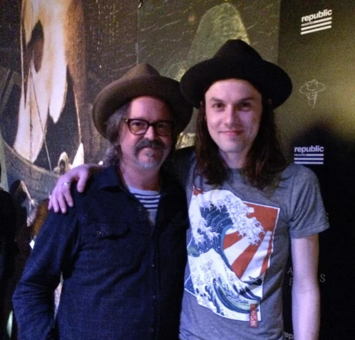 Two musicians posing at a Republic Records backdrop