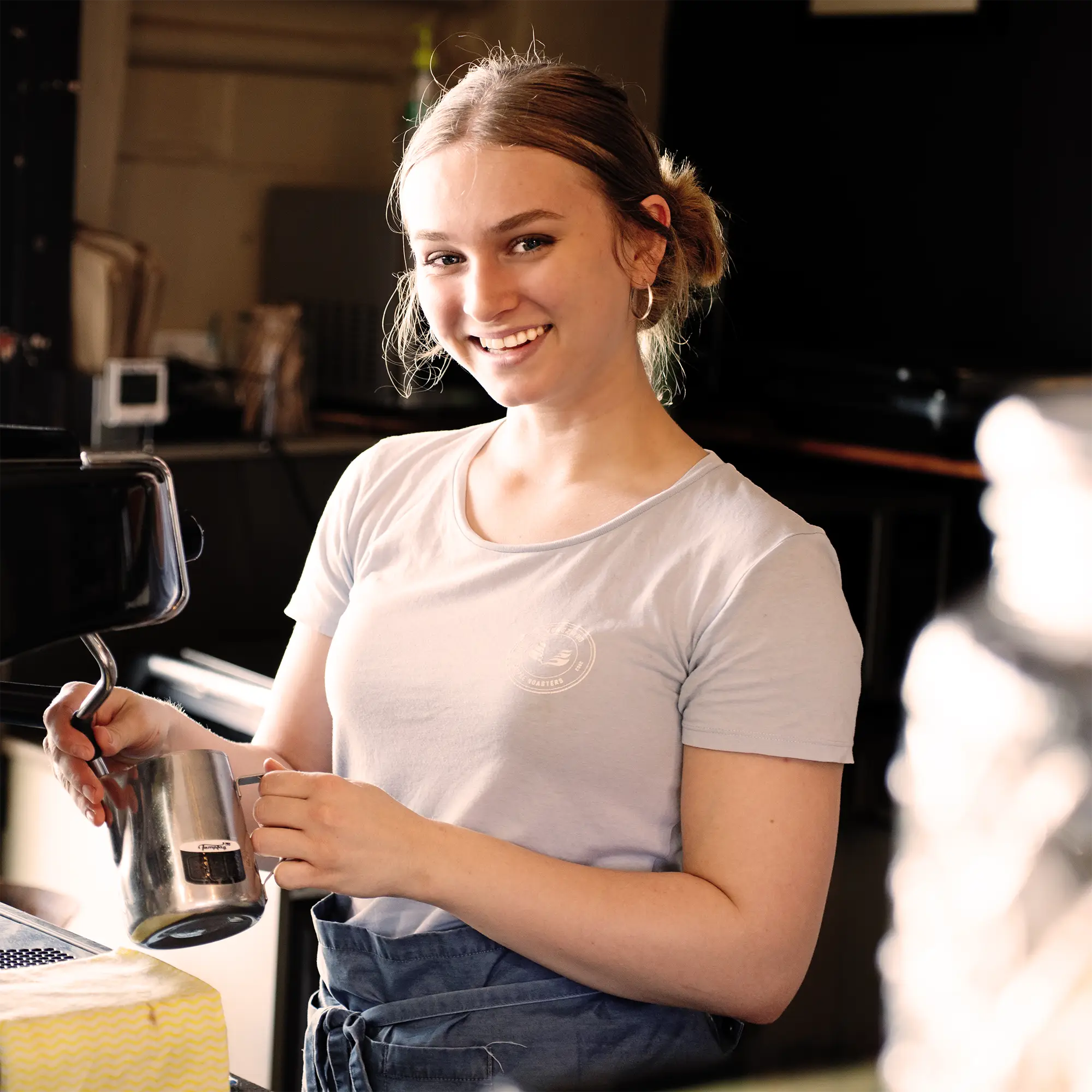 Paragon Espresso Bar Barista, Bronte, smiling while she steams milk