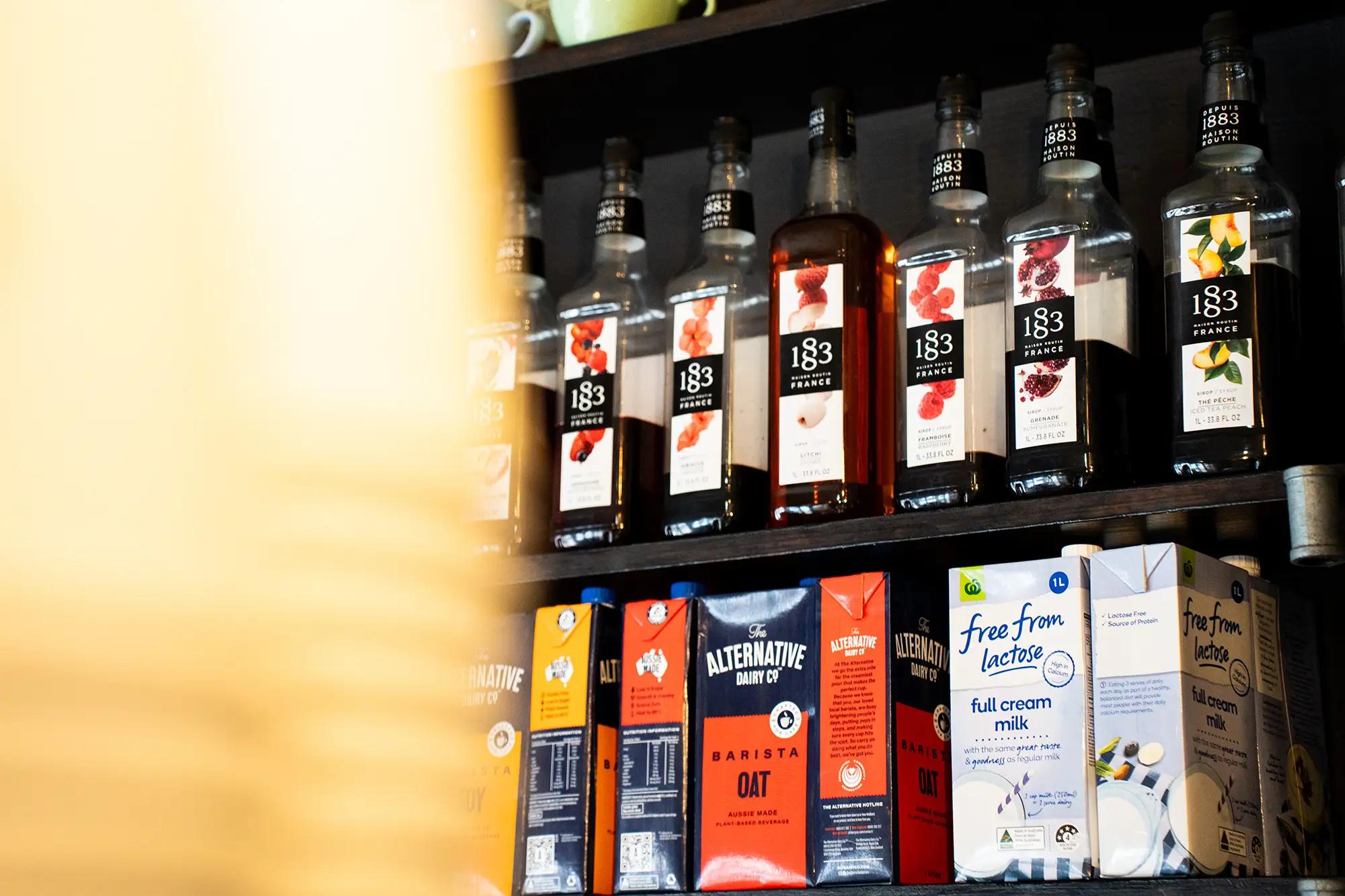 Shelf behind the Espresso Bar with all the Italian lemonade syrup flavours