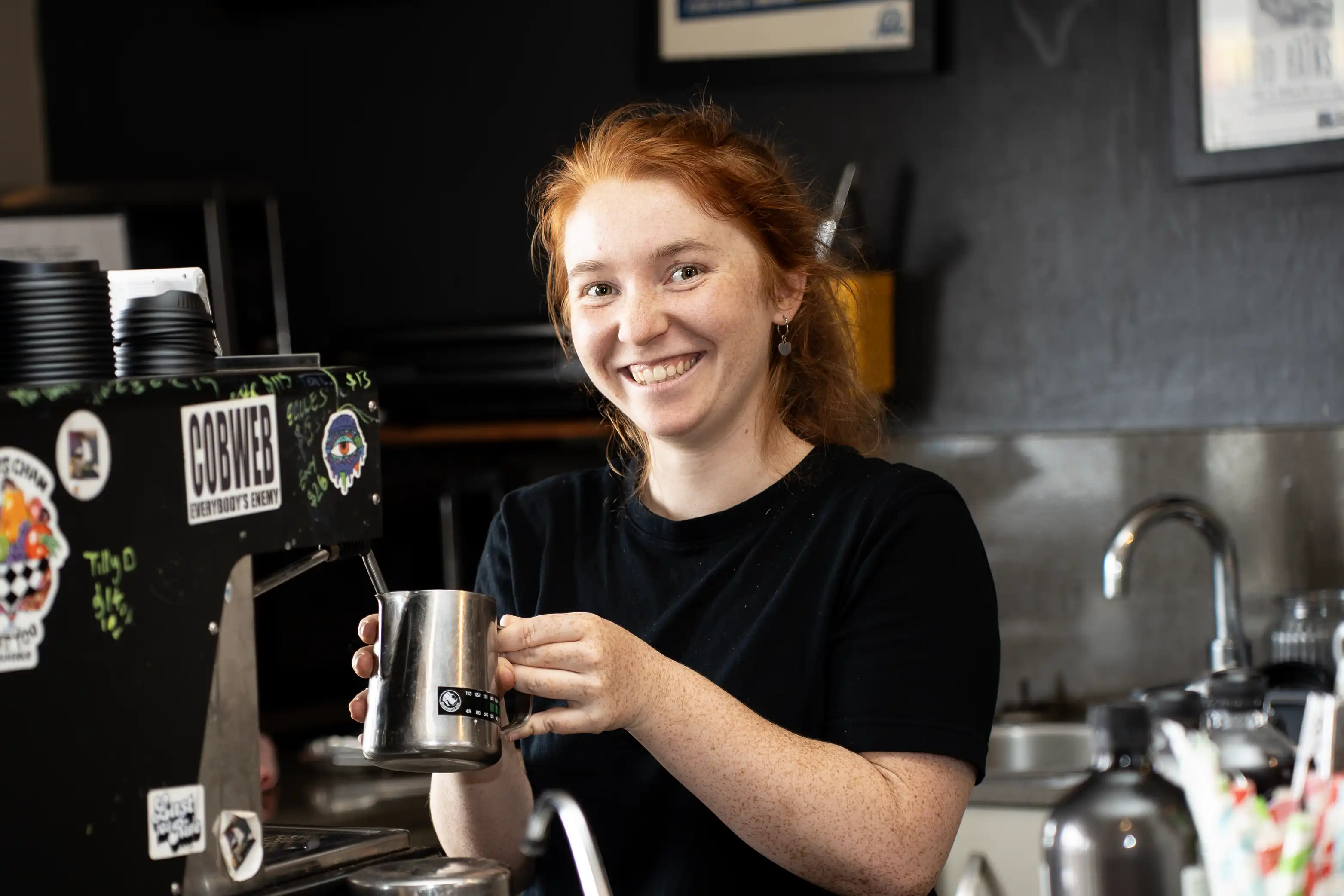 Manager, Marley, steaming a jug of milk on the espresso machine