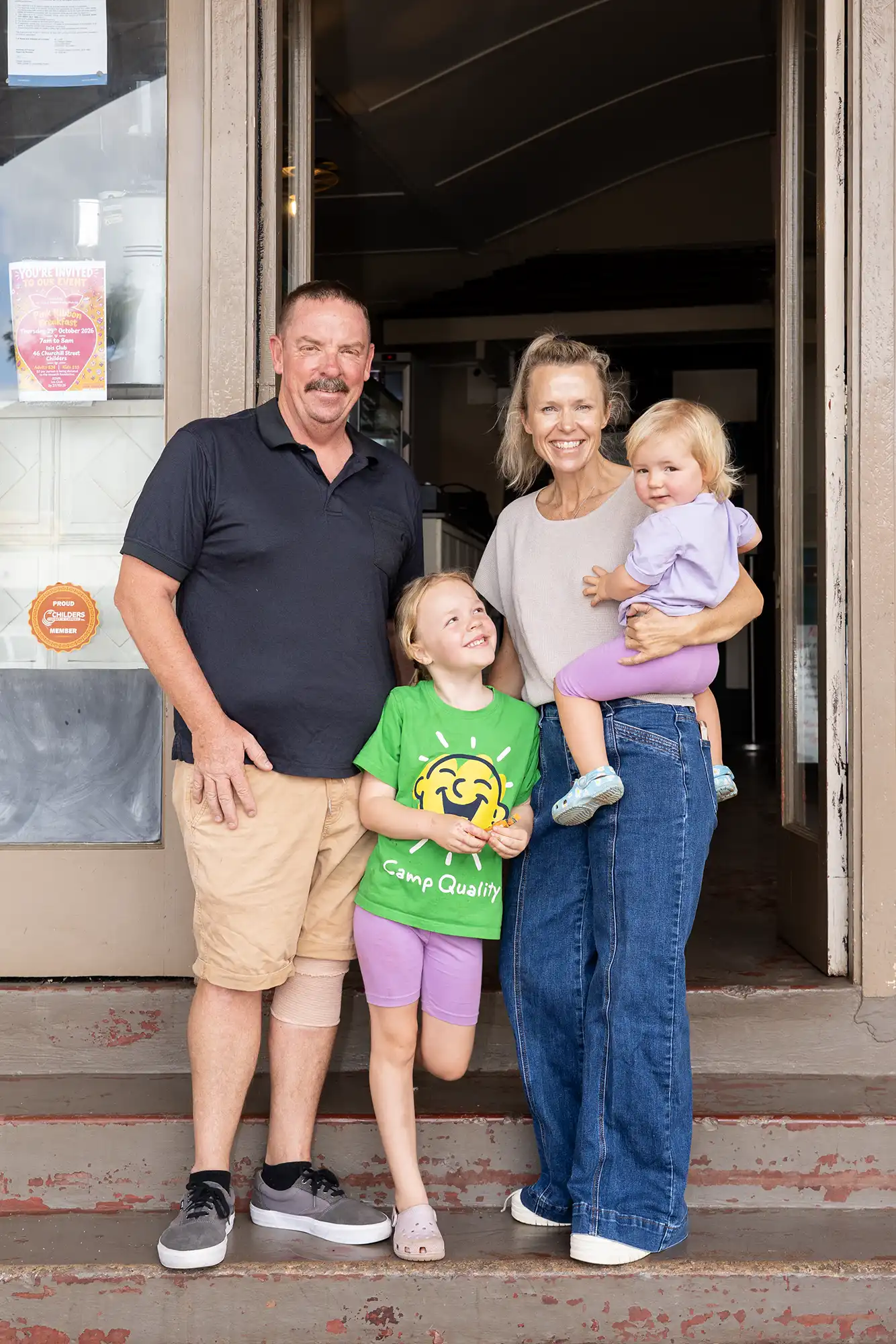 Jeremy and Catherine (Marley's Parents), along with Marley's siblings smiling at the entrance of the Paragon Espresso Bar