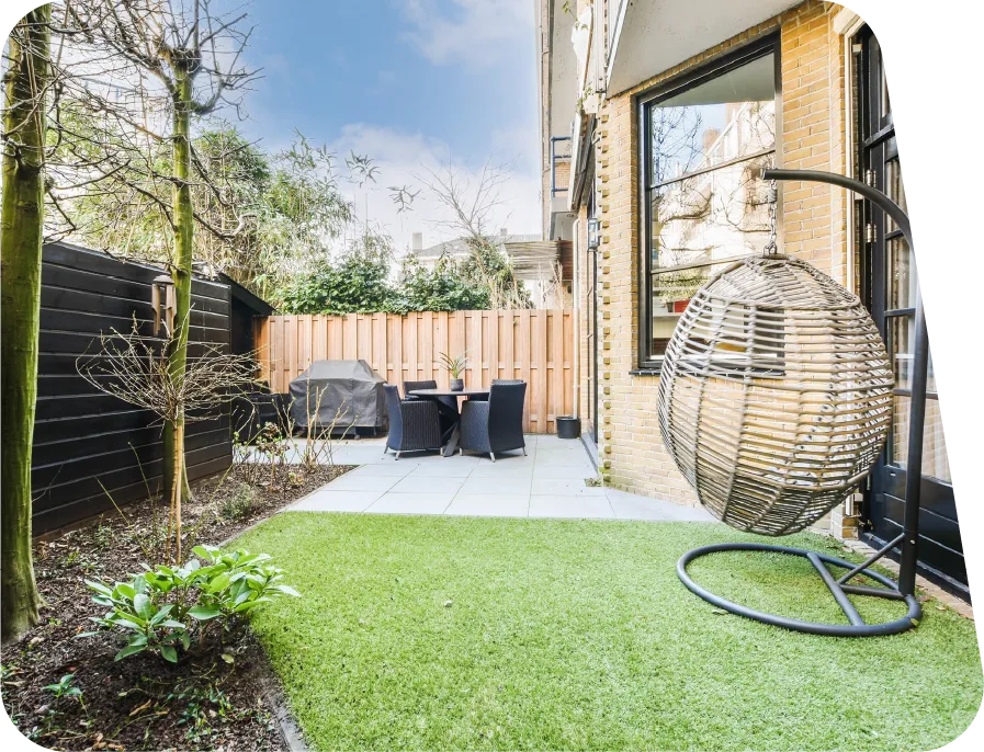 Artificial lawn with nice surrounding garden area and outdoor seating