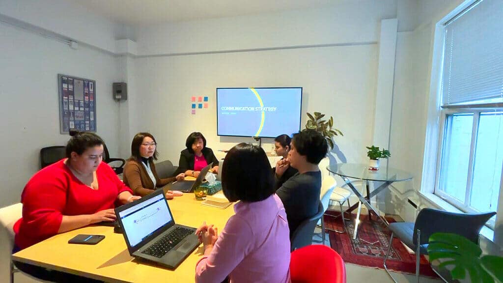 Magnolia colleagues collaborating around a meeting room table