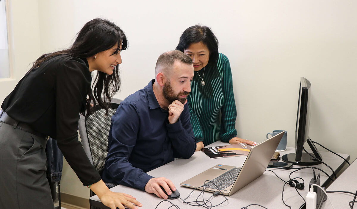 Team reviewing work together on a screen