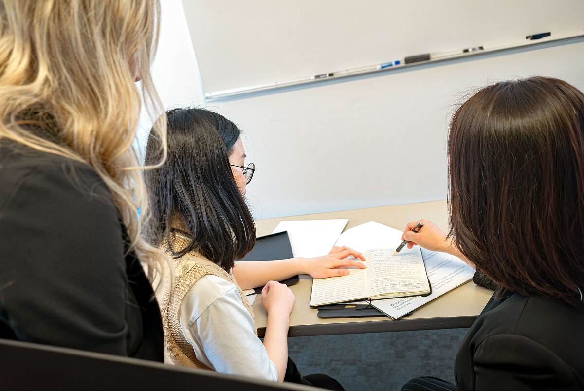 Colleagues reviewing notes together