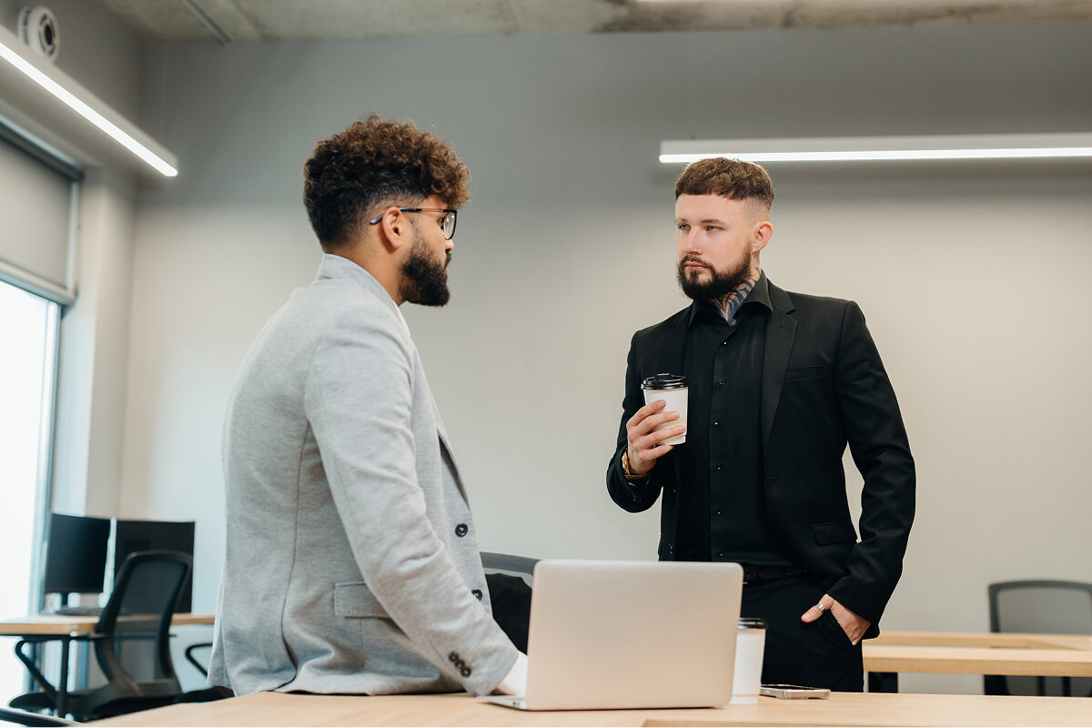 Colleagues talking over coffee in the office