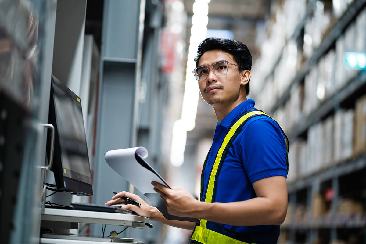 Worker managing warehouse inventory